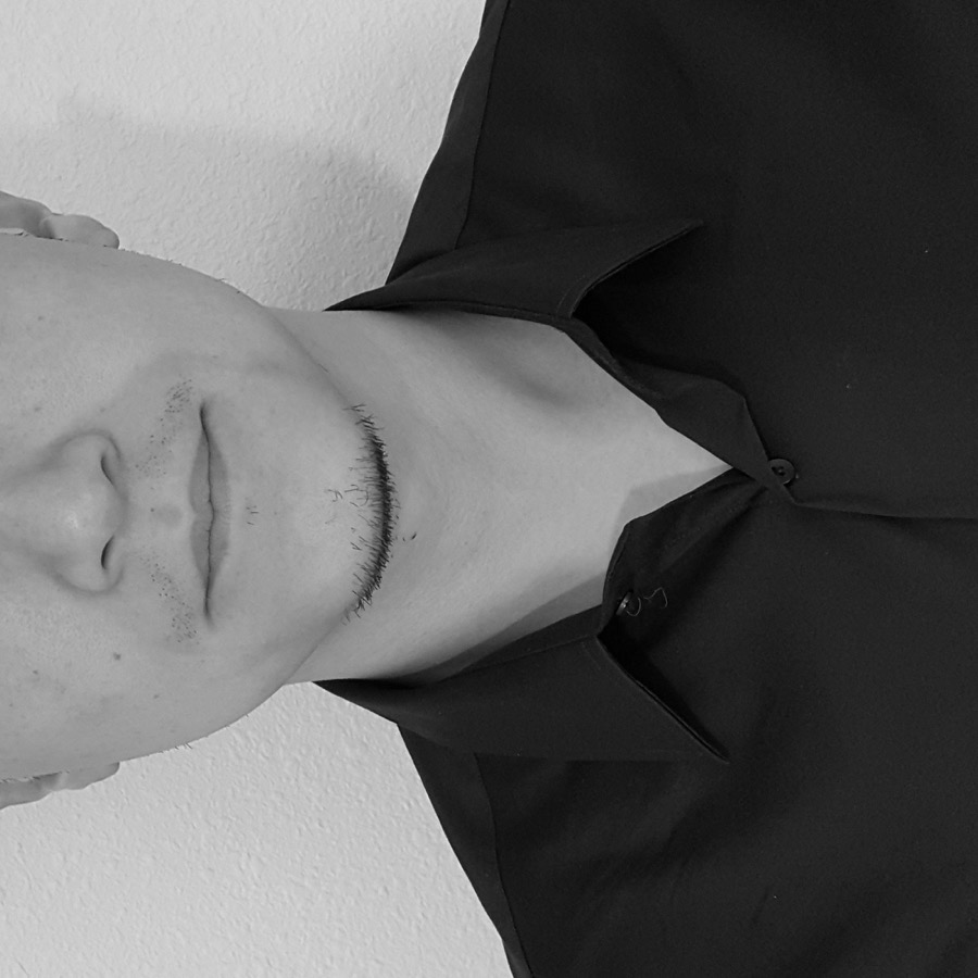 Rudy Chou smiling in a business suit